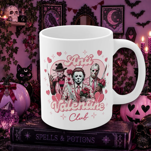 A white ceramic mug with a Halloween-themed Valentine's Day graphic reading 'Ari's Valentine Club' and featuring three horror movie characters with roses and hearts, displayed on a dark book in a spooky purple decorative setting.