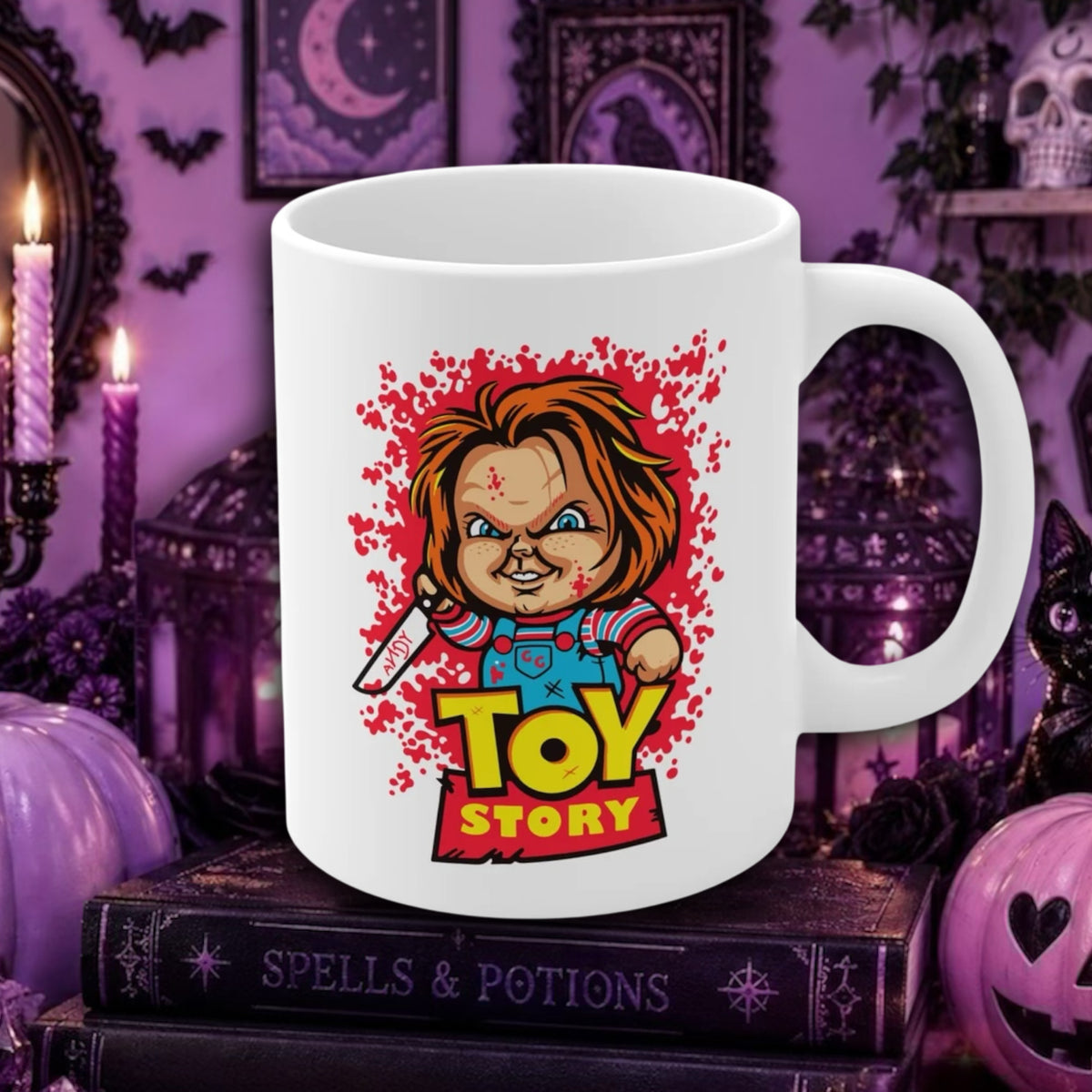 A white ceramic mug featuring a cartoon illustration of Chucky holding a knife, with the words 'TOY STORY' in large yellow letters. The mug is displayed on a stack of books in a spooky purple-themed room setting with candles, bats, and pumpkins.