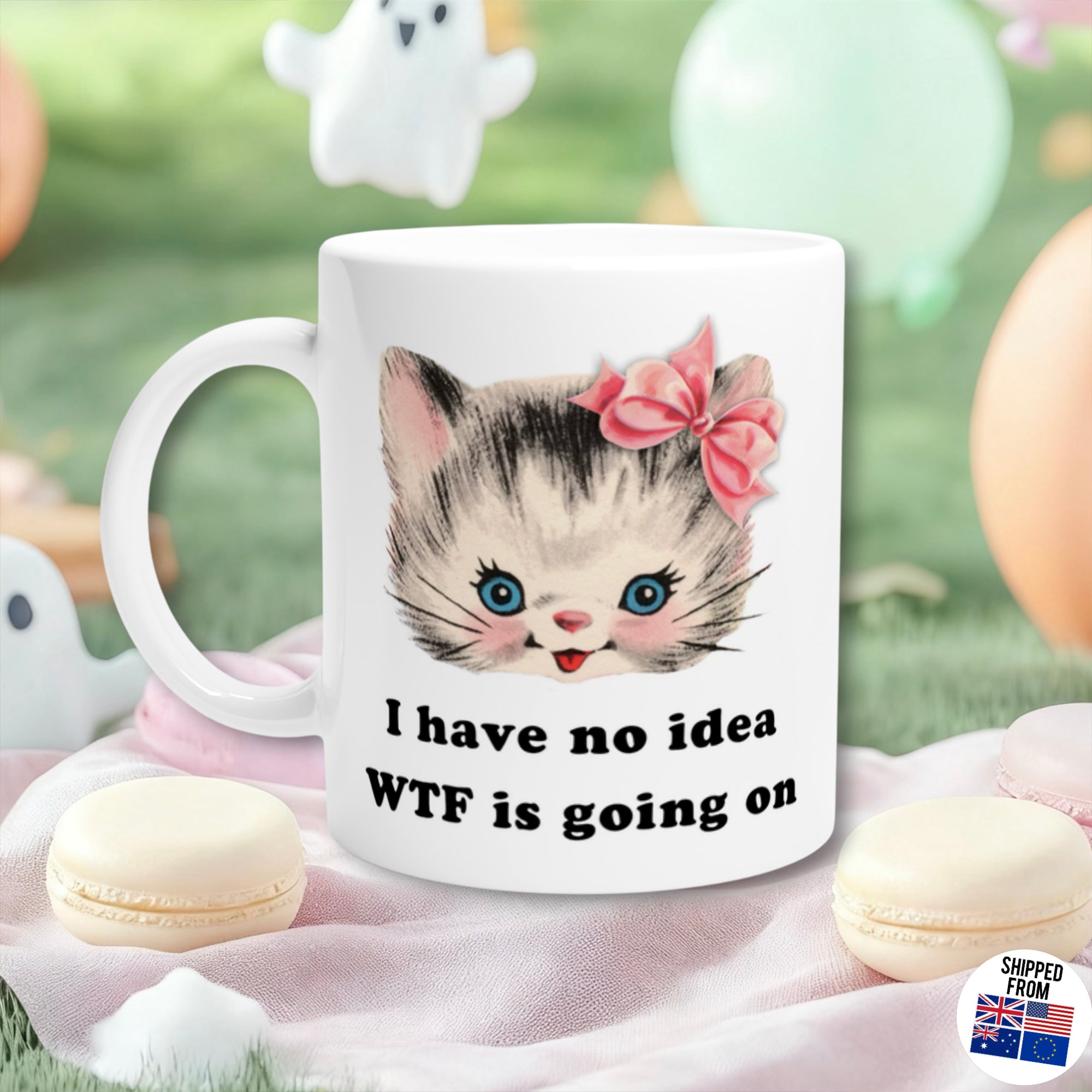 Retro Kitsch Mug with a cat illustration and funny text 'I have no idea WTF is going on' on a soft pink surface with macarons.