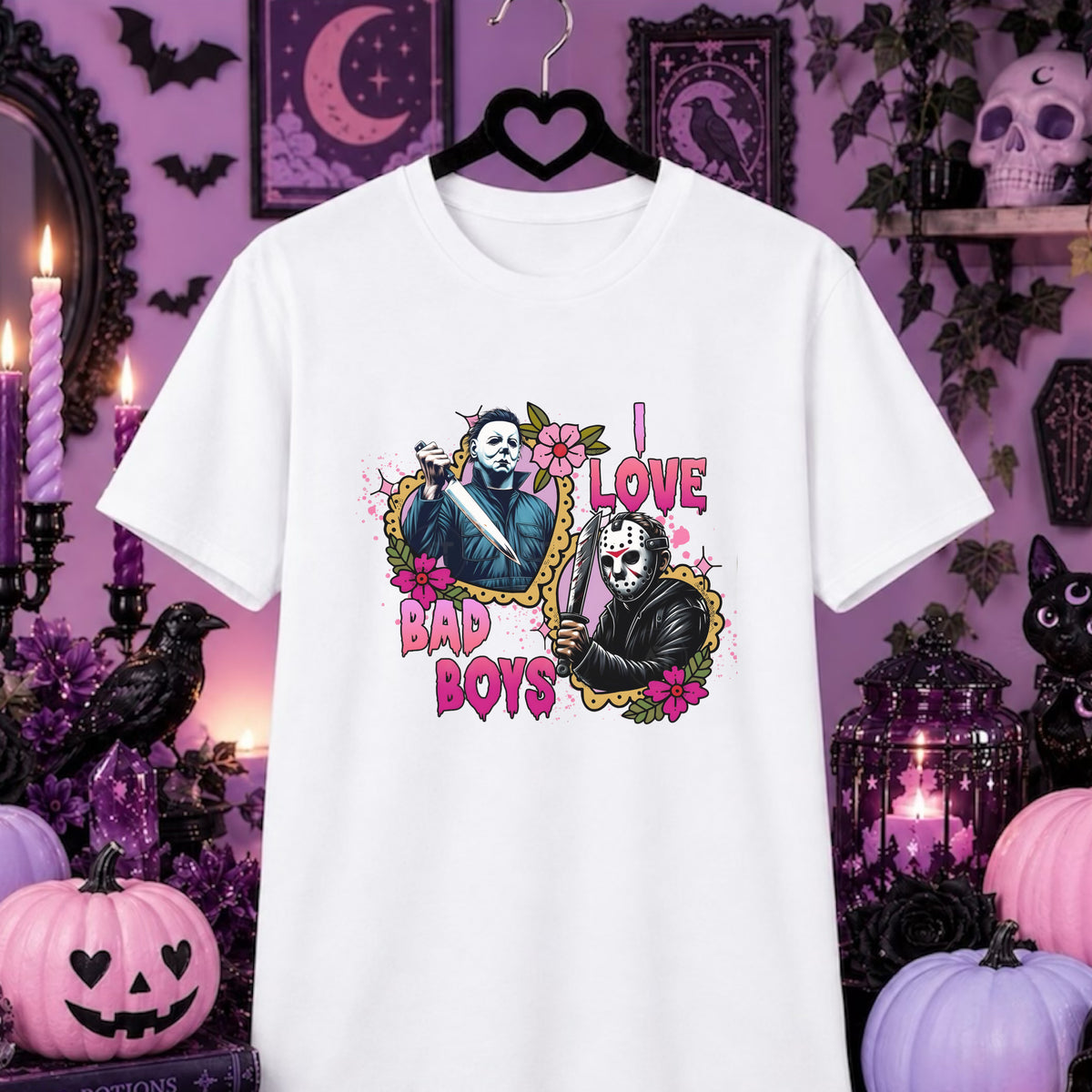 I love Bad Boys, Horror movies, Halloween  T-Shirt.  White short-sleeve graphic T-shirt hanging on a black hanger against a Halloween-themed purple background with pumpkins, candles, bats, and a skull. The shirt features a colorful front print of two masked figures and the text 'I LOVE BAD BOYS'.