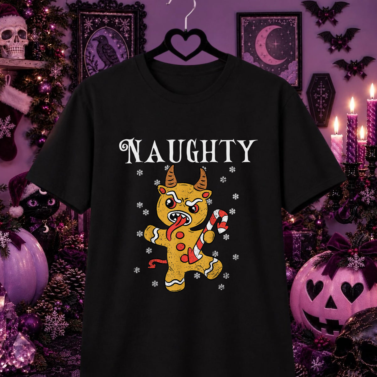 A black short-sleeve t-shirt hanging on a black hanger against a Halloween-themed purple background. The shirt features a graphic of a gingerbread Krampus holding a candy cane, with the word 'NAUGHTY' printed above in a white gothic font.