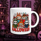 A white ceramic mug with a colorful cartoon Halloween Labubu graphic and the word 'HALLOWEEN' in red dripping letters, displayed on a gothic-themed shelf with candles, framed moon art, and a book labeled 'SPELLS & POTIONS'.
